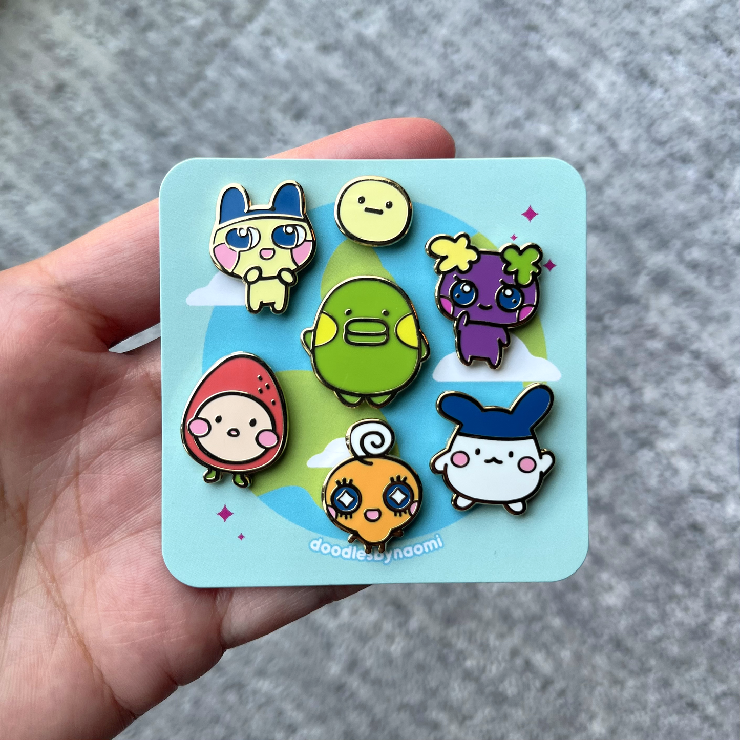 All six pet character pins featured on custom pin backing card.